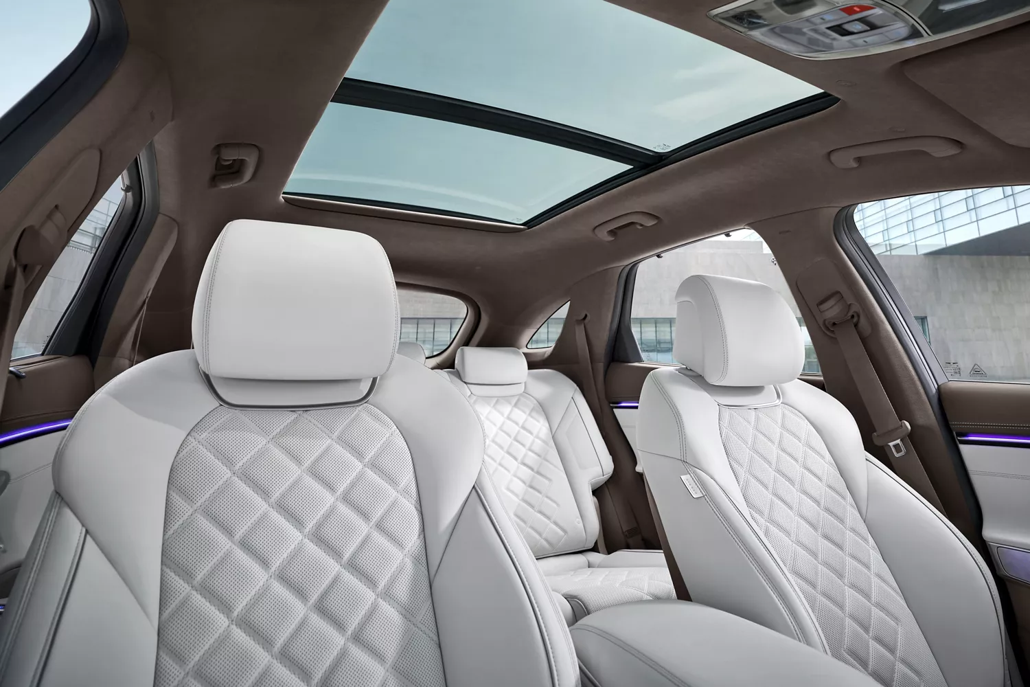 Interior view of white quilted nappa leather front and rear seats inside Genesis Electrified GV70