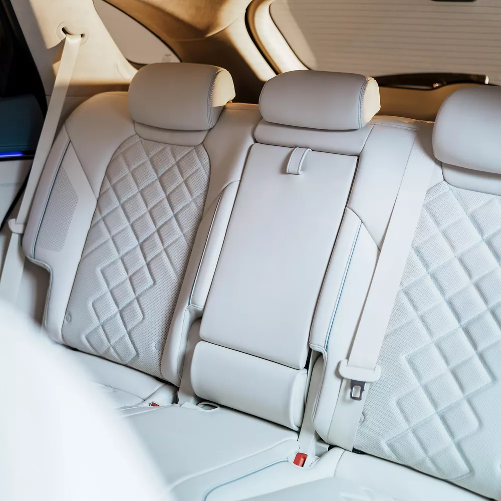 Interior view of white quilted nappa leather rear seating inside Genesis Electrified GV70