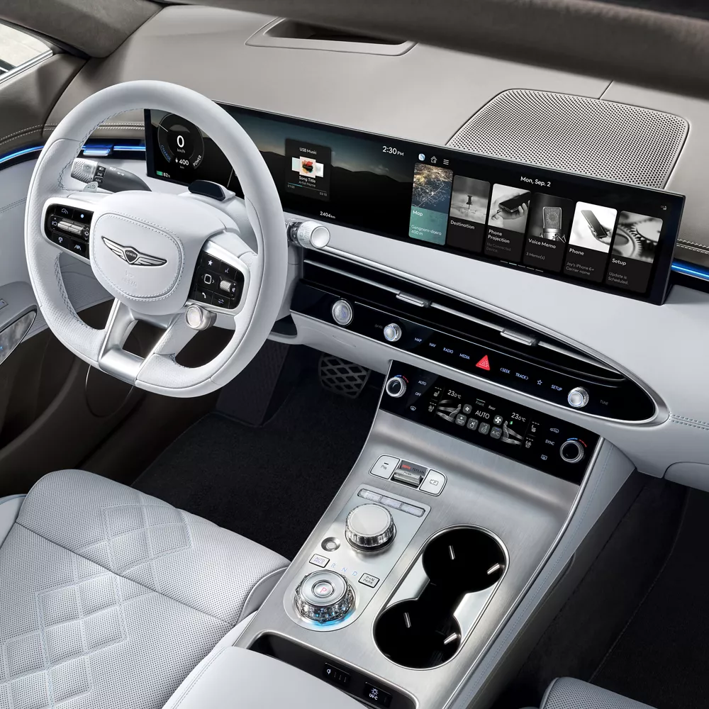 Interior view of steering wheel, front dash and front seats in fog gray on Genesis Electrified GV70