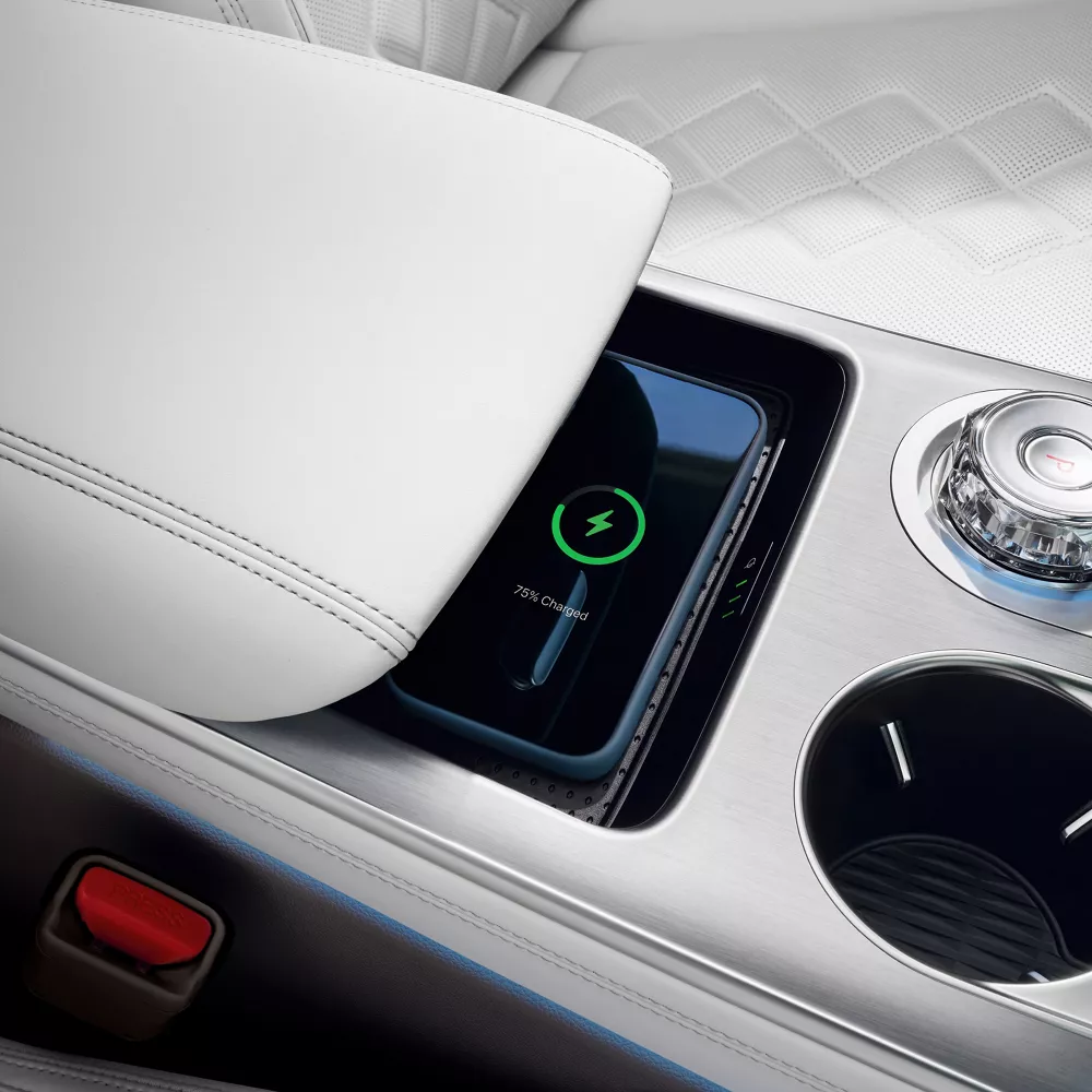Interior closeup of wireless charging pad on center console inside Genesis Electrified GV70