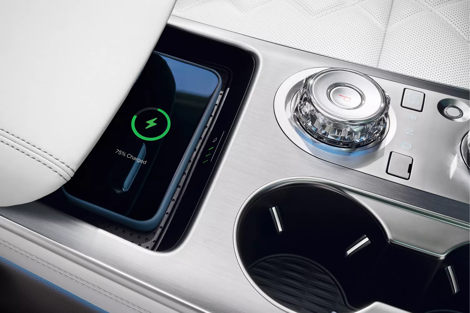 Interior closeup of wireless charging pad on center console inside Genesis Electrified GV70