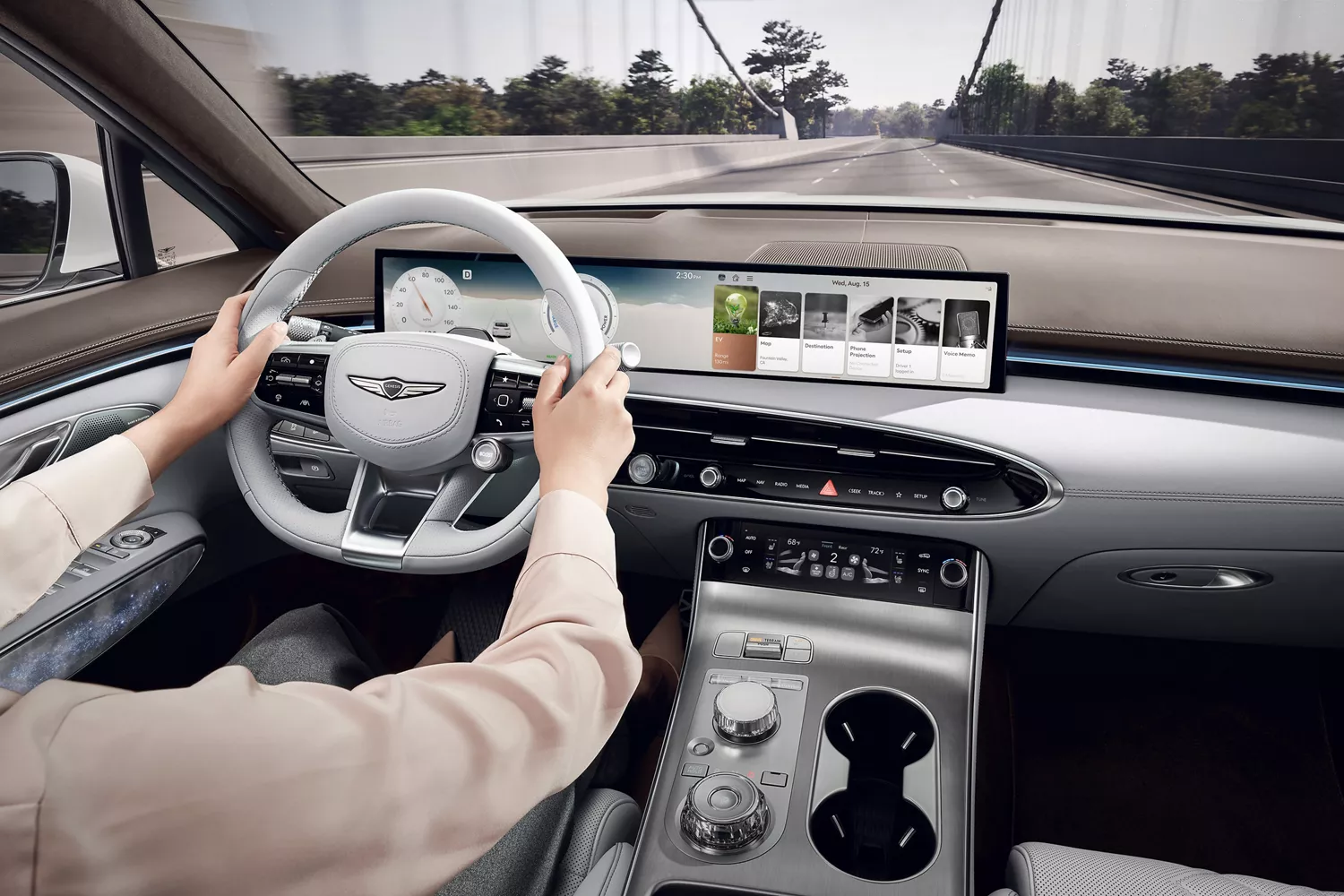 Interior close up from driver POV of hands on steering wheel inside Genesis Electrified GV70