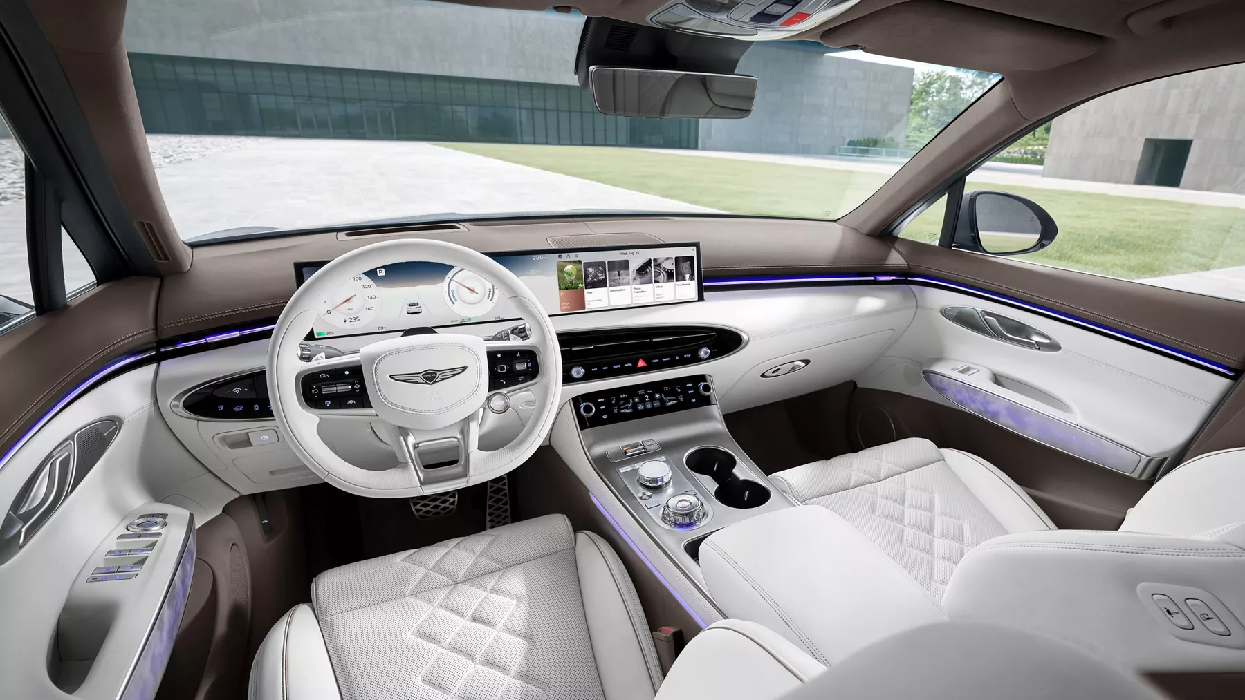 Interior driver pov of Genesis Electrified cockpit with ambient lighting and quilted nappa leather