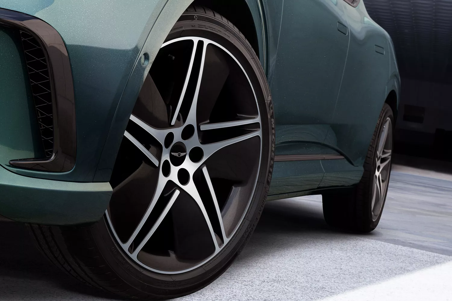 Driver side close up of wheel details on 2026 Genesis GV60 in Tromso Green