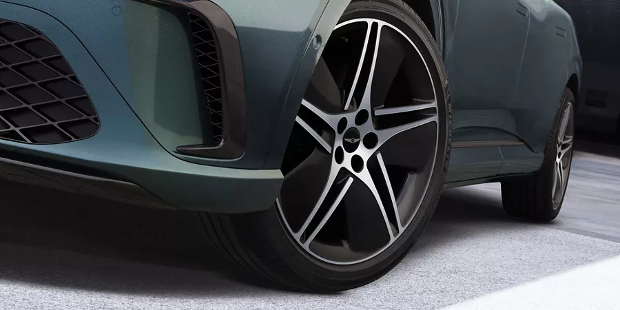 Driver side close up of wheel details on 2026 Genesis GV60 in Tromso Green