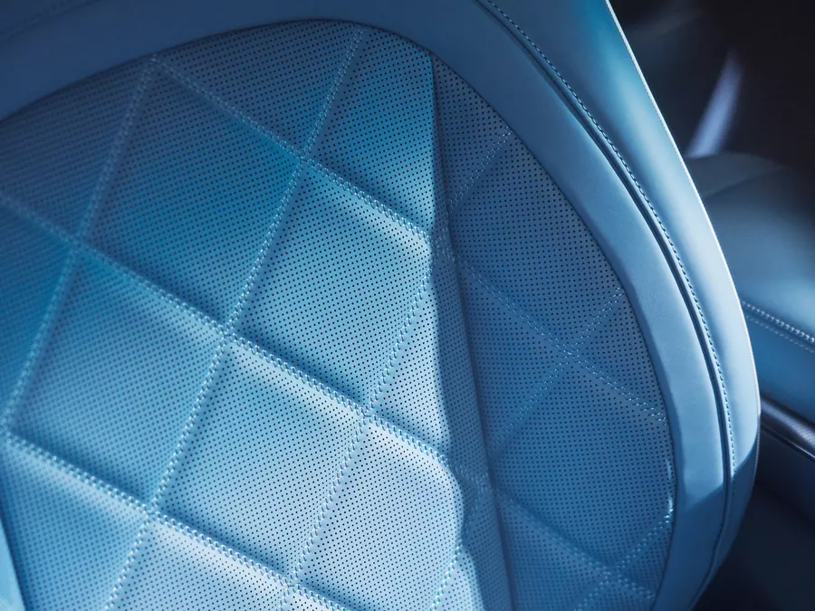 Close up interior shot of 2026 Genesis GV60 blue nappa leather seat with diamond quilting