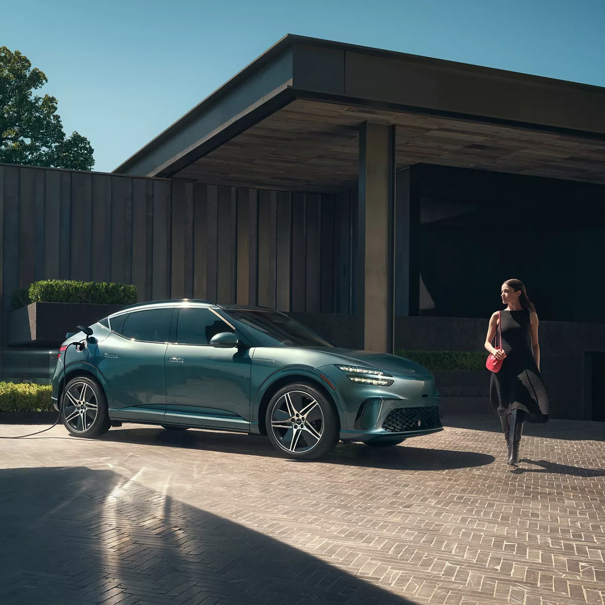 3/4 Rear Driver Side shot of Genesis GV60 in Hanauma Mint parked along snowy city street
