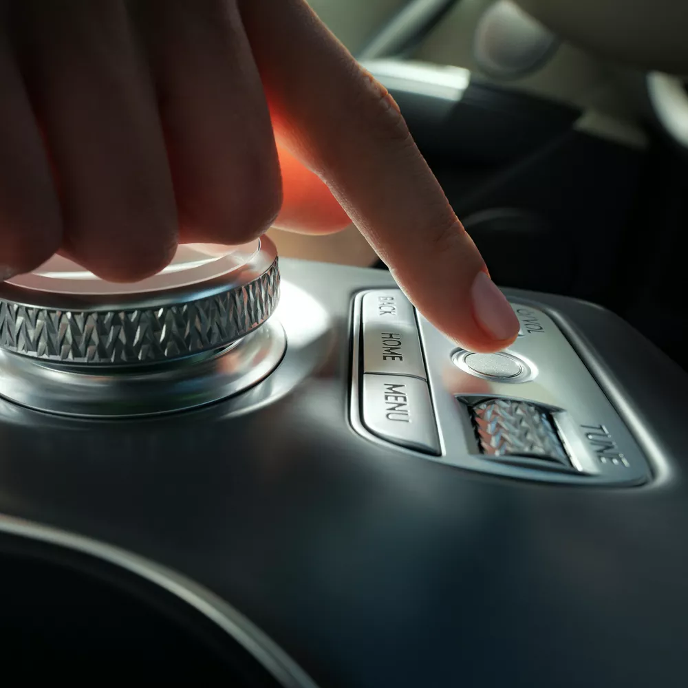 Interior close up of hand point to center console fingerprint reader, inside Genesis GV60