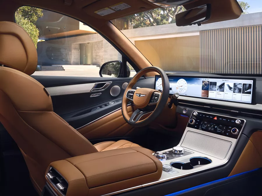 Interior view from passenger seat of Genesis GV80 cockpit in Dune tan color