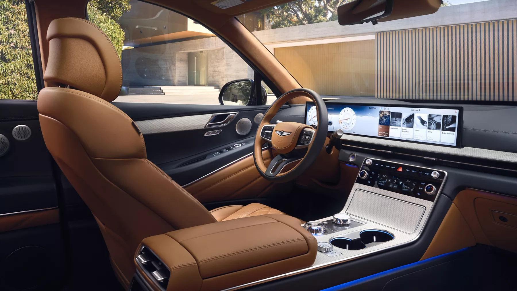 Genesis GV80 interior with tan leather seats, highlighting wide OLED infotainment screen