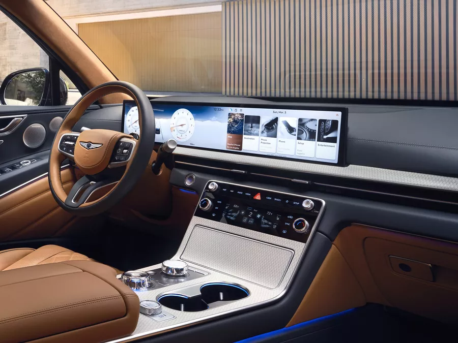 Genesis GV80 interior with tan leather seats, highlighting wide OLED infotainment screen