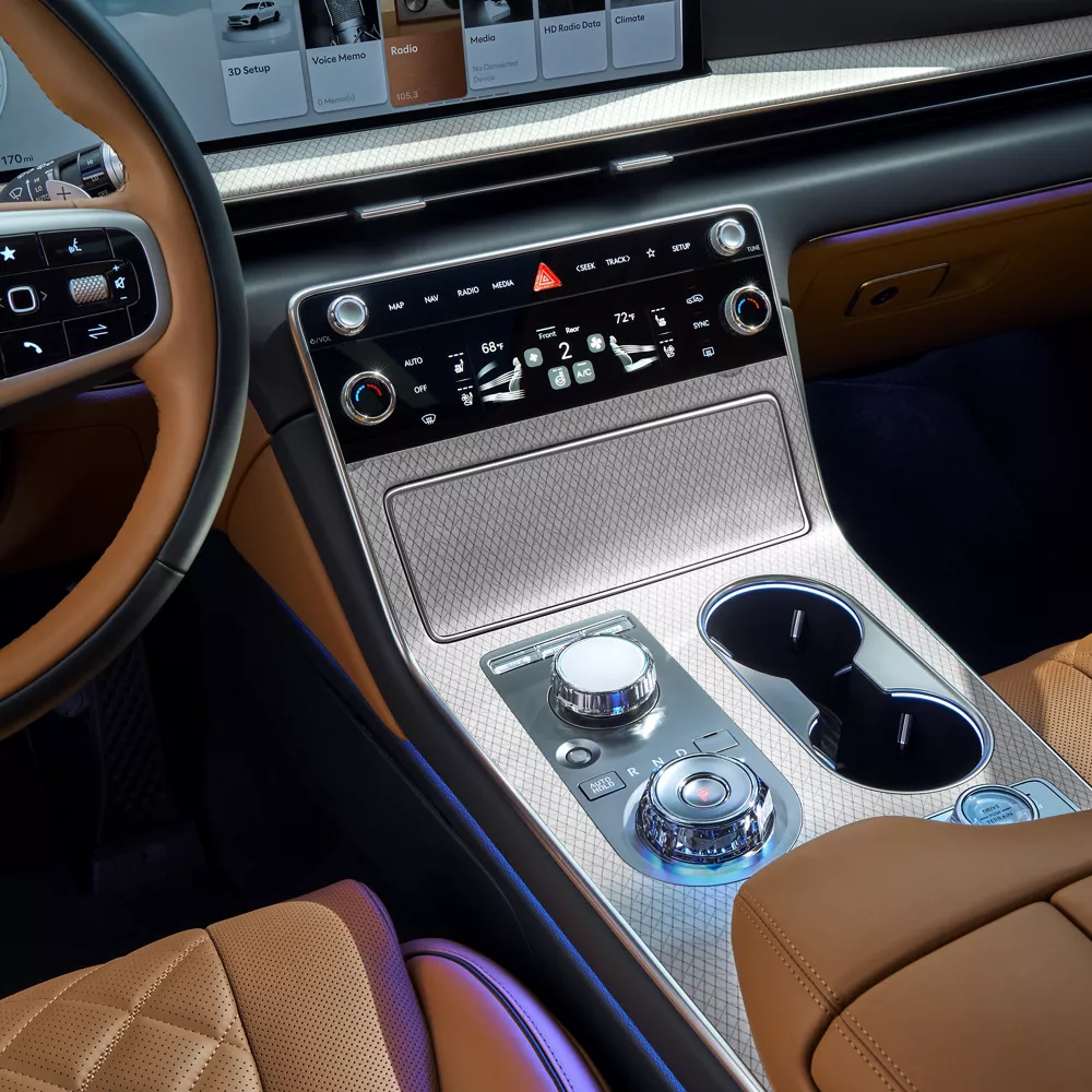 Interior close up of center console controls and dials inside the Genesis GV80