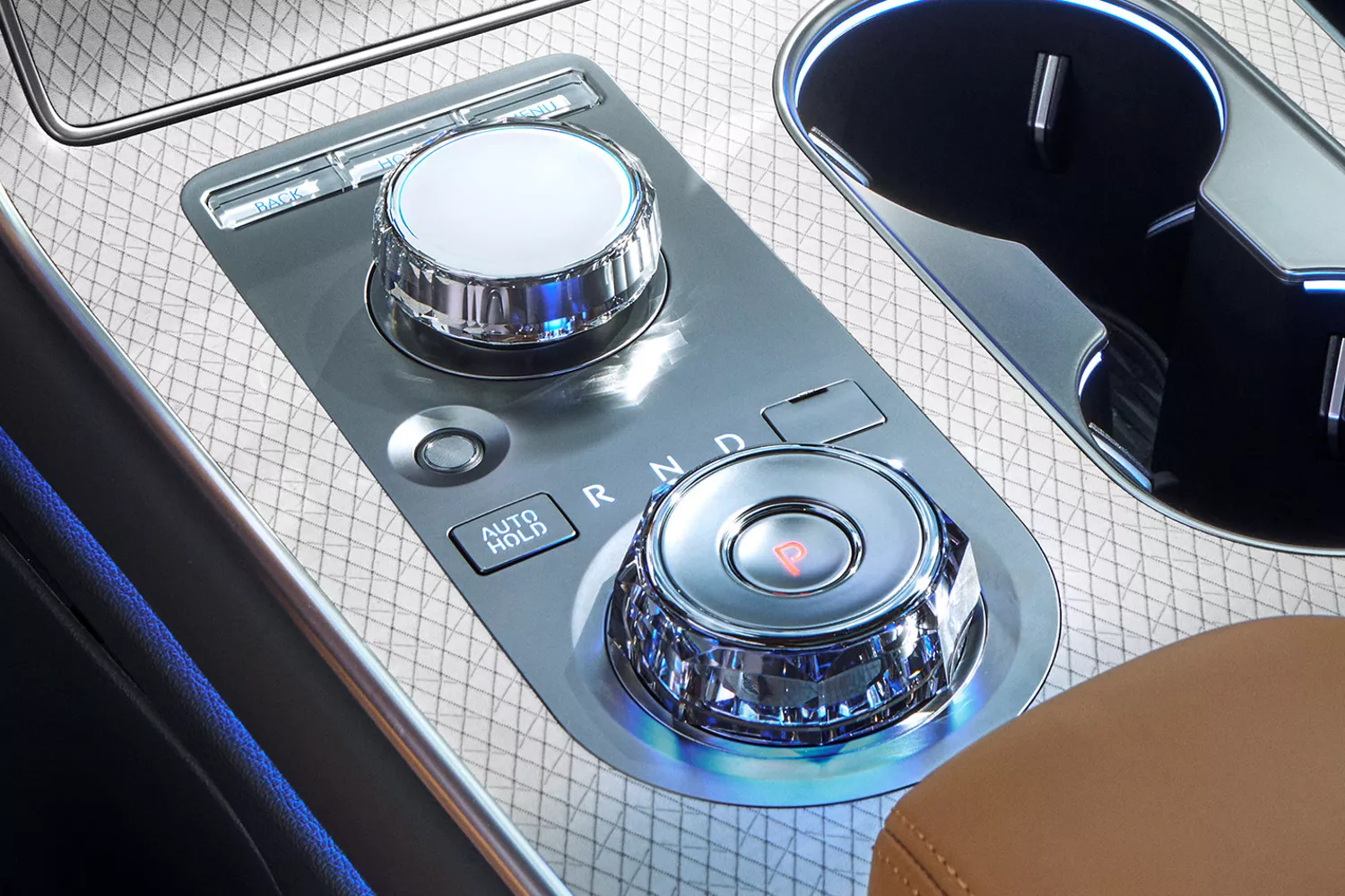 Interior close up from driver seat of center controls and dials inside Genesis GV80