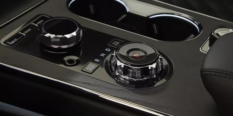 Interior close up of the shift knob & cupholder in the center console of Genesis GV80 Prestige Black