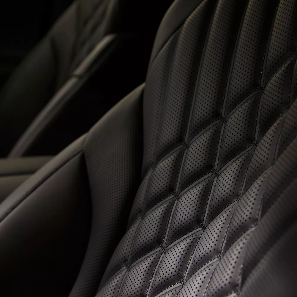 Interior close up view of quilted Nappa leather seating details on Genesis GV80 in Prestige Black