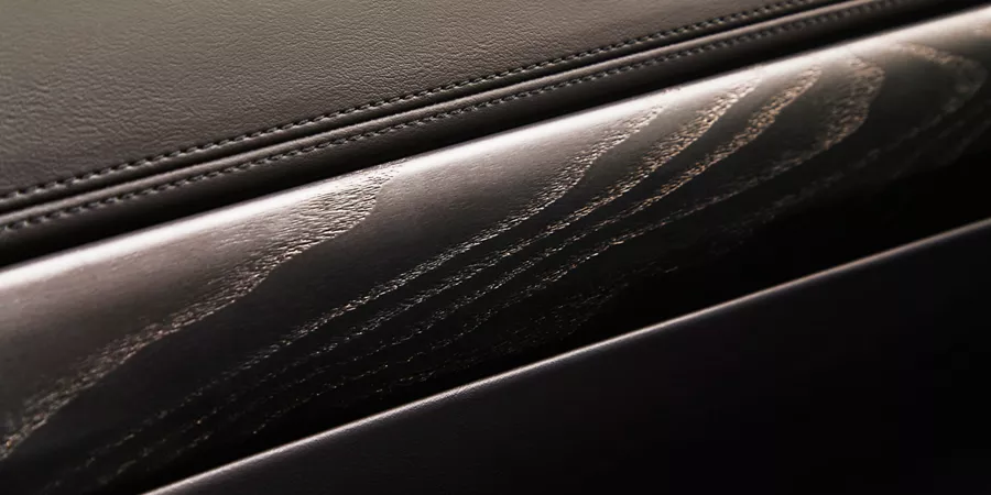 Interior close up of wood paneling details inside Genesis GV80 in Prestige Black