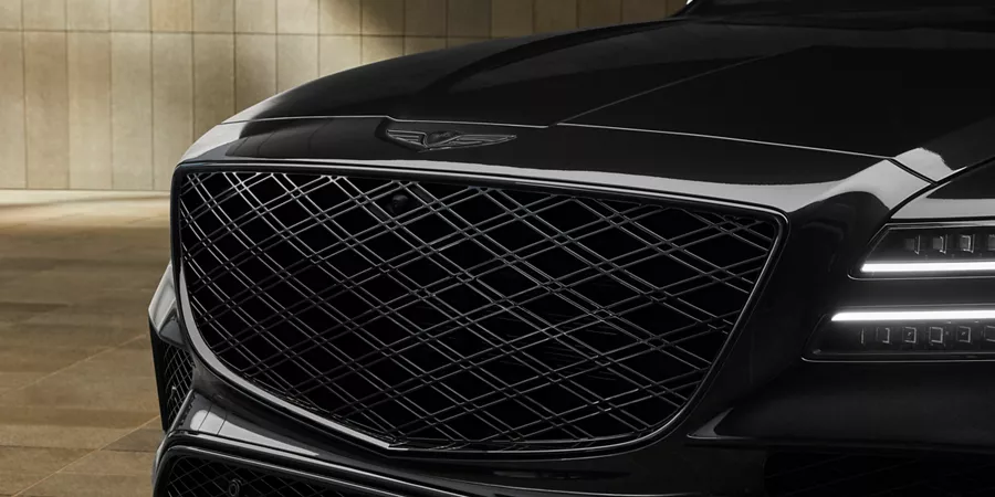 Close up view of grille and headlight details on Genesis GV80 in Prestige Black