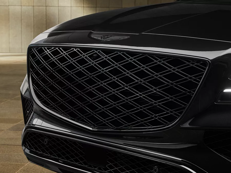 Close up view of grille and headlight details on Genesis GV80 in Prestige Black