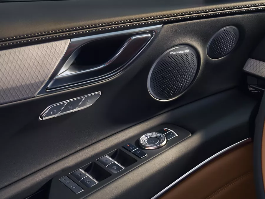 Interior close up of Bang & Olufsen speakers on driver side door panel inside Genesis GV80