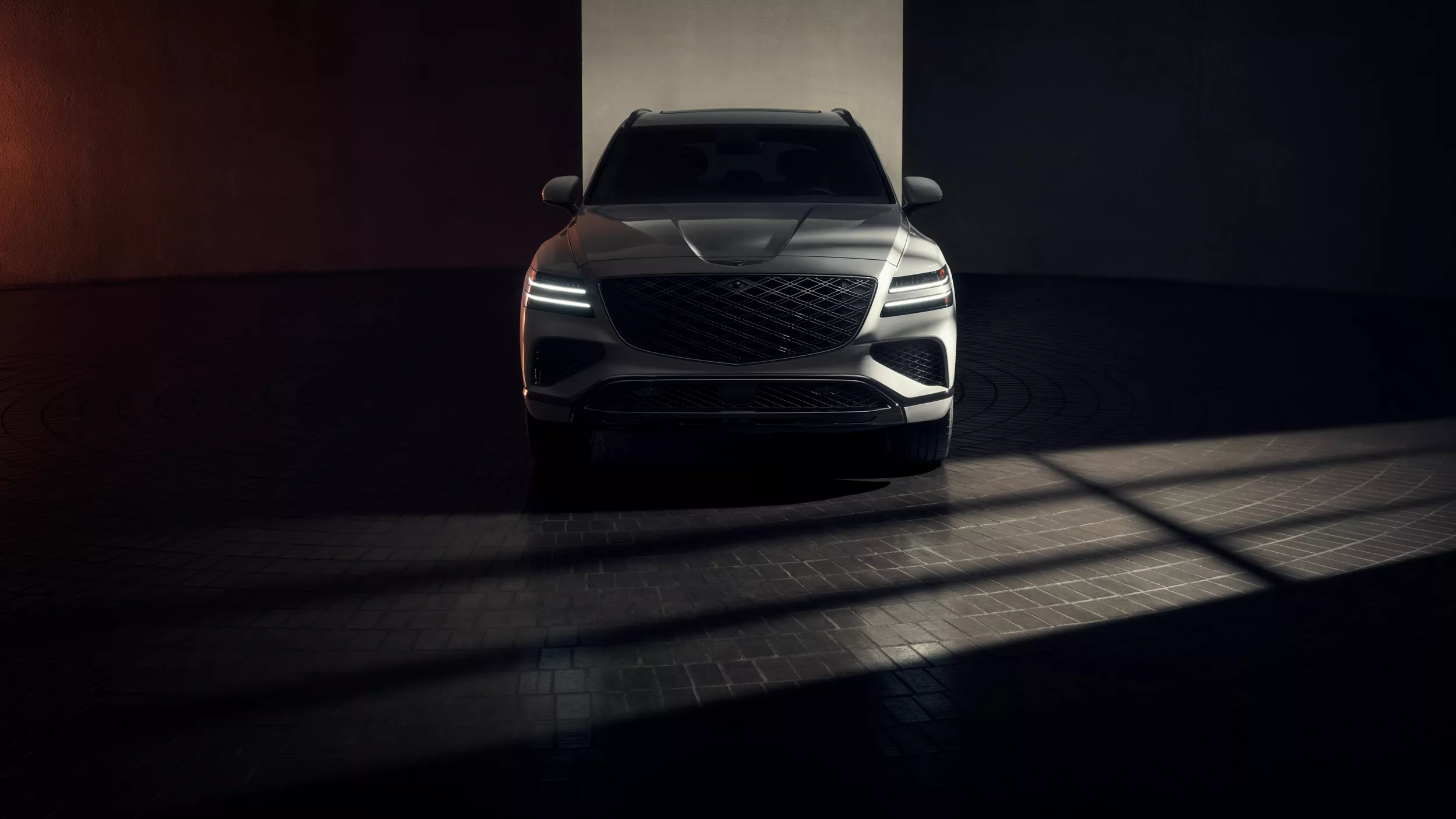 Front view of 2026 Genesis GV80 Prestige Black in Uyuni White exterior