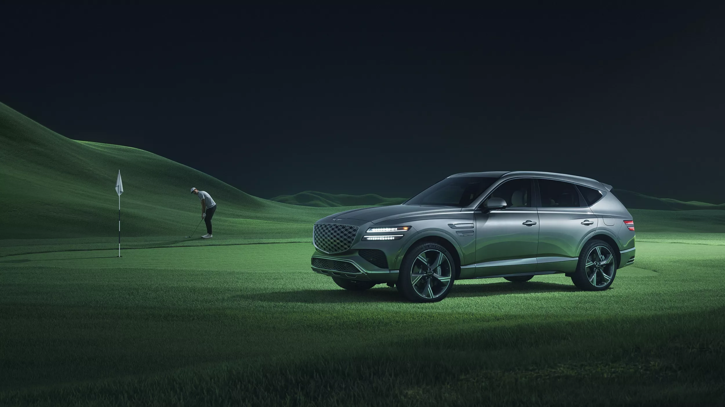 Overhead view of 2026 Genesis vehicle in Prestige Black trim, left half of the vehicle illuminated