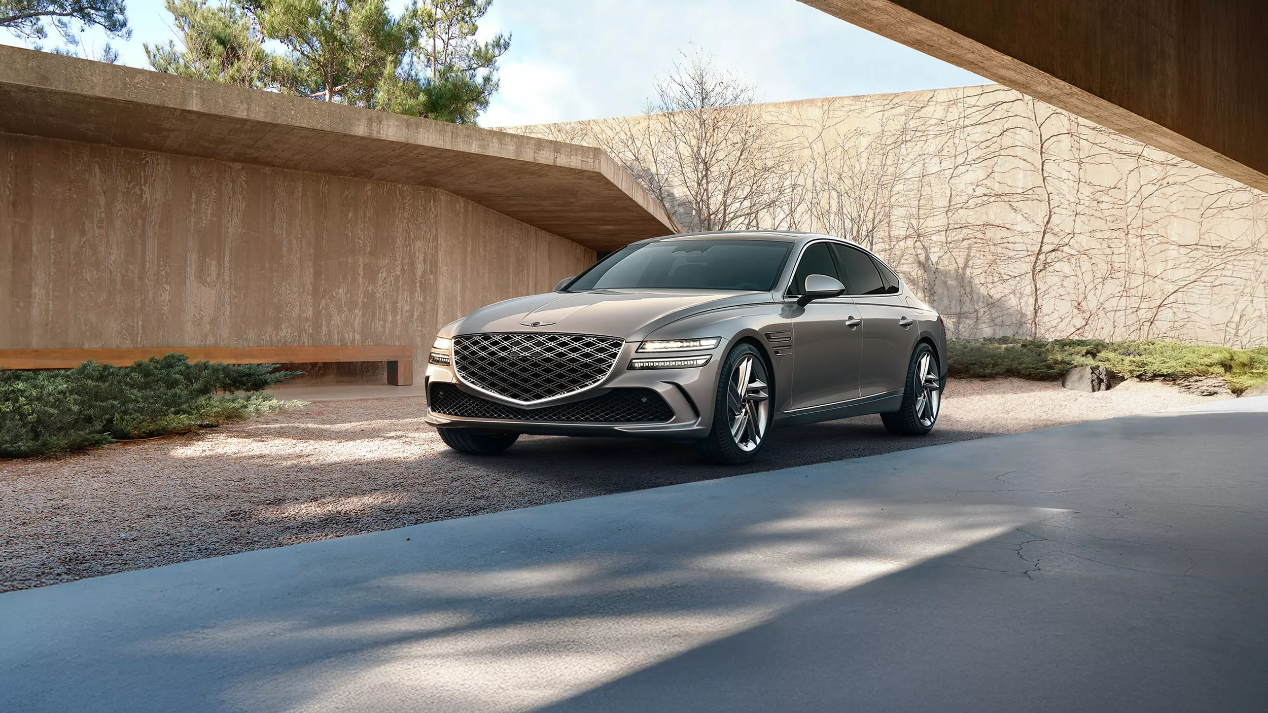 3/4 front driver side view of 2026 Genesis G80 parked in front of modern house