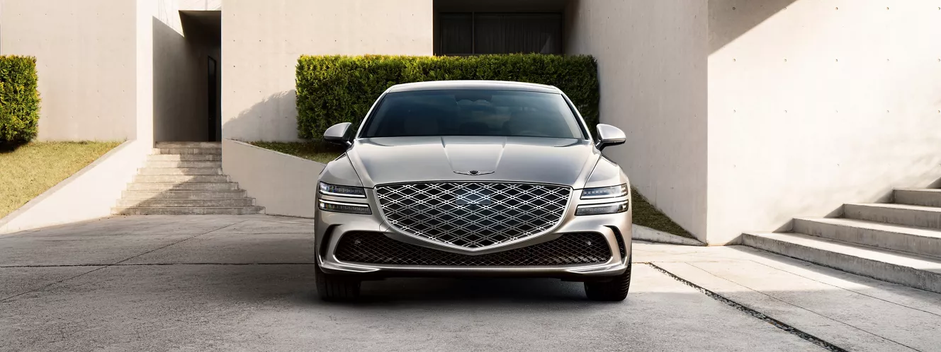 Front view of Genesis G80 parked in front of modern home