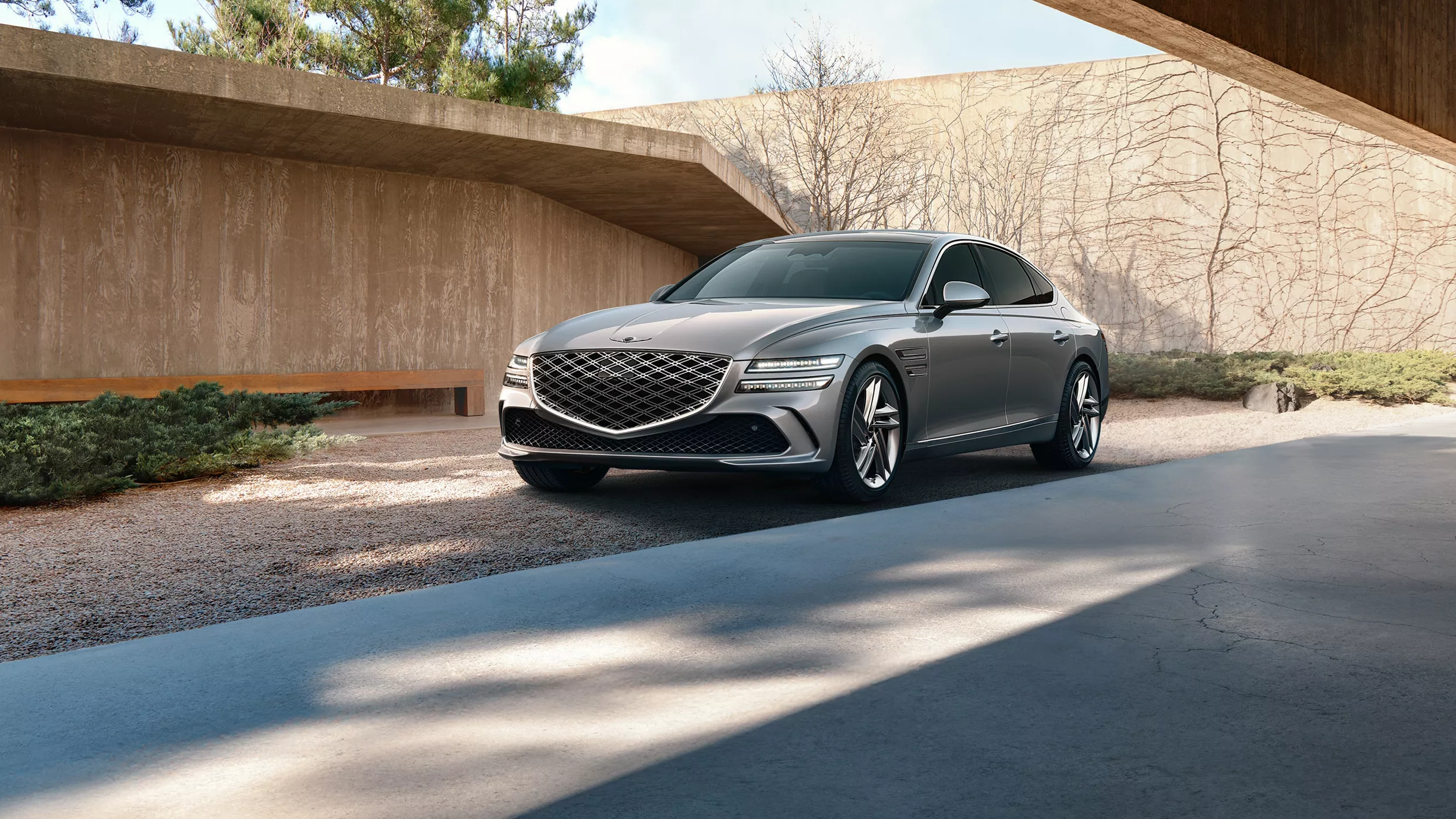 3/4 front driver side view of 2026 Genesis G80 parked in front of modern house
