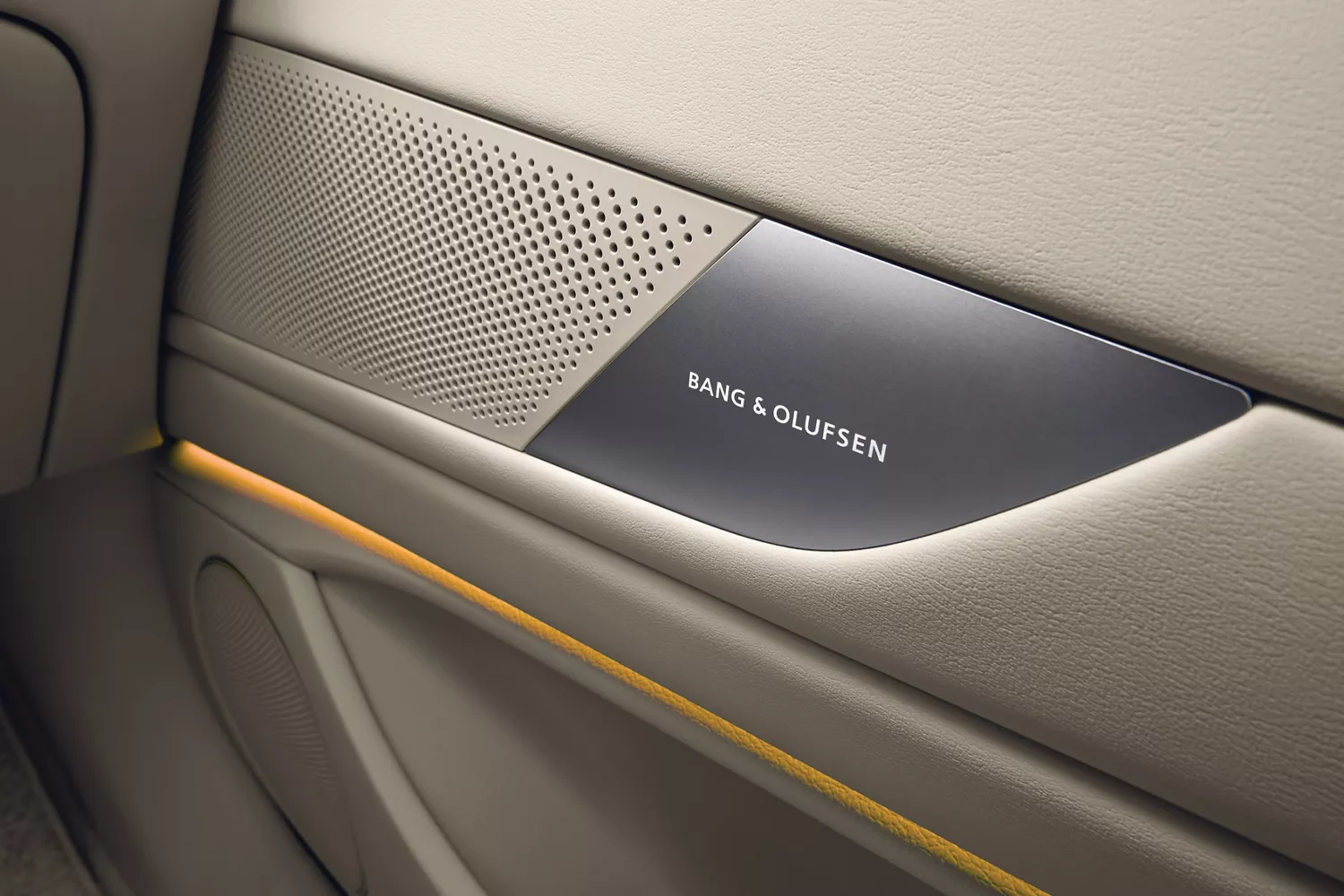 Close up of Bang & Olufsen speaker system in beige interior door of Genesis G80