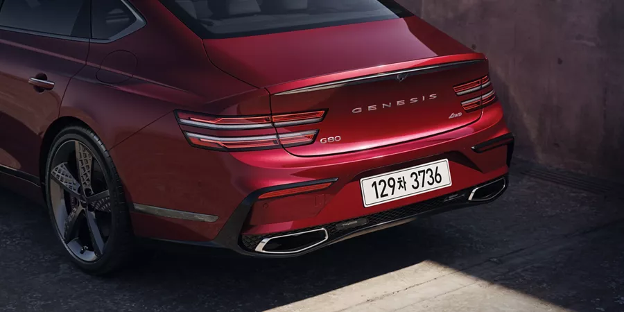 3/4 rear driver side close-up of Genesis G80 in Cavendish Red