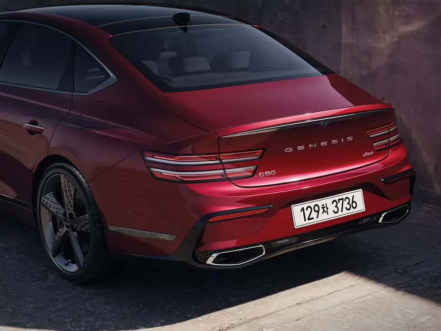 3/4 rear driver side close-up of Genesis G80 in Cavendish Red