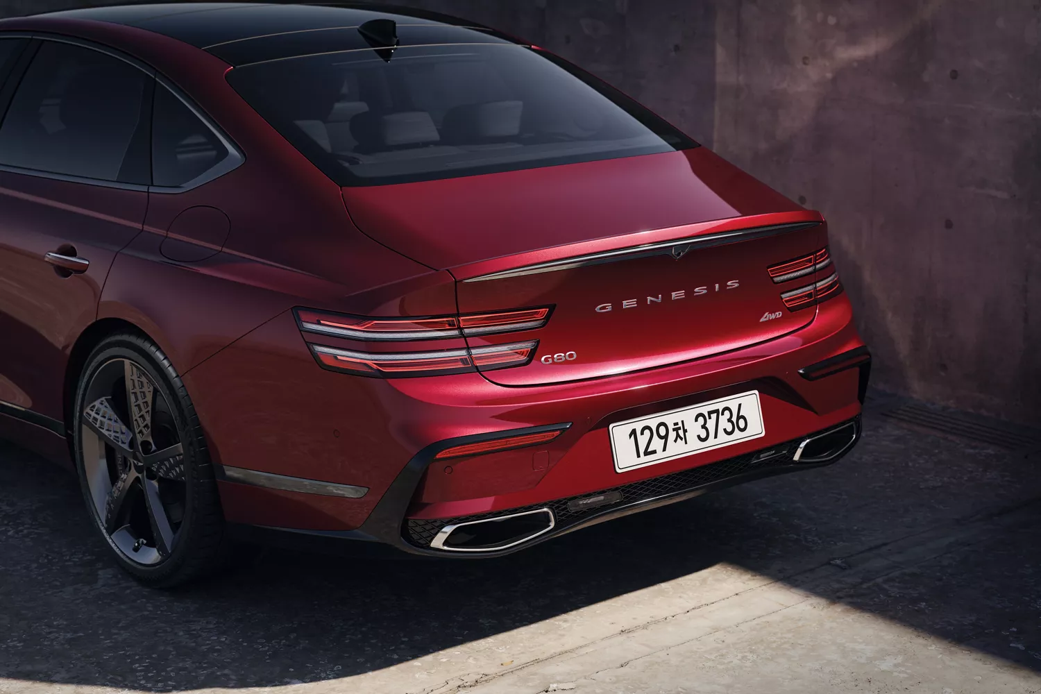 3/4 rear driver side close-up of Genesis G80 in Cavendish Red