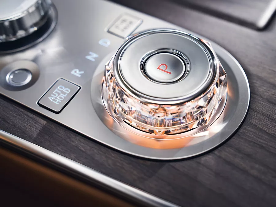 Interior close up shift by wire gear selector wheel with red ambient light inside the Genesis G80