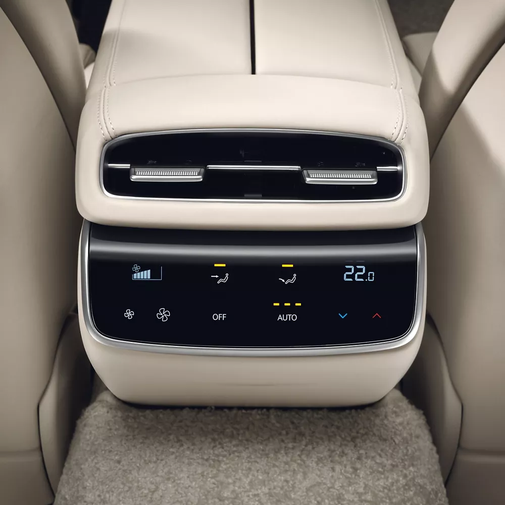 Interior closeup from rear seat pov of climate control display on center console inside Genesis G80