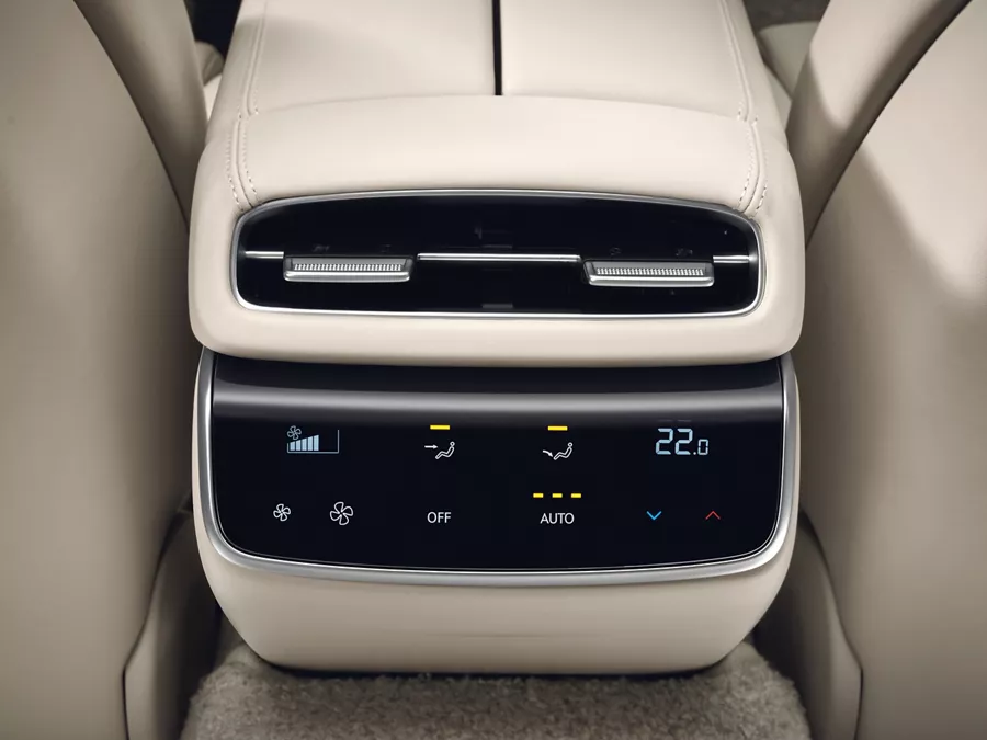 Interior closeup from rear seat pov of climate control display on center console inside Genesis G80