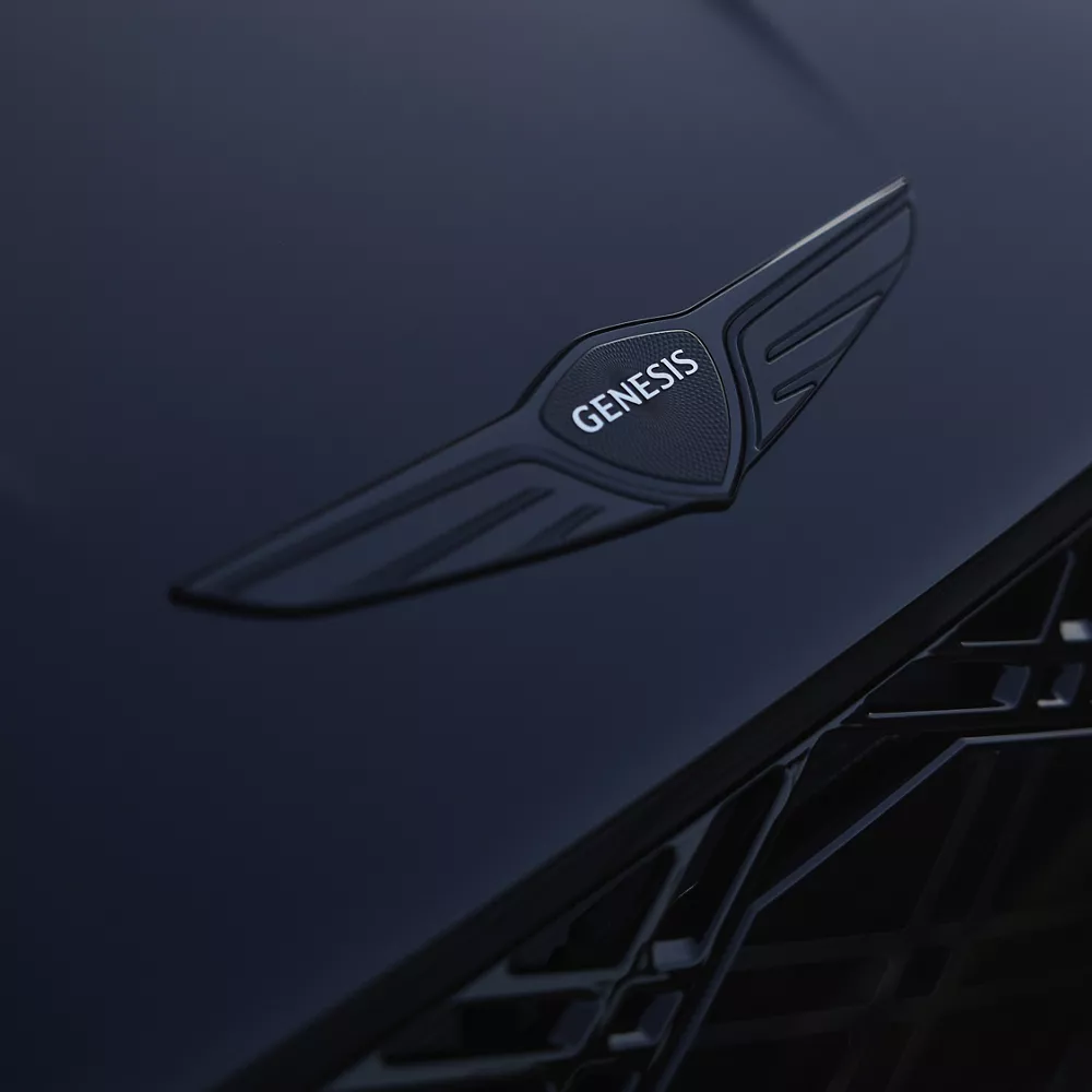 Close up of Genesis logo emblem on the hood of the 2026 Genesis G80 Prestige Black