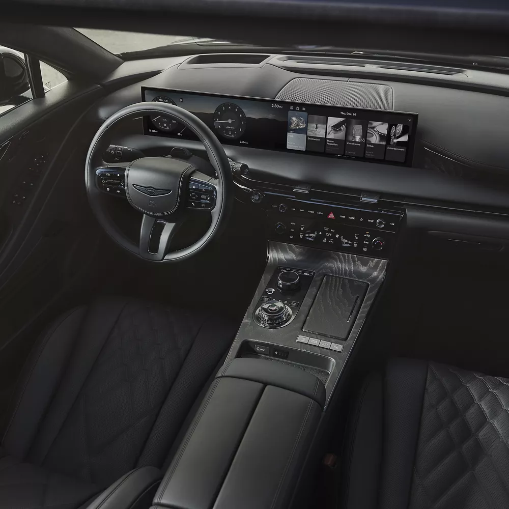 Downward view of Genesis G80 Prestige Black cabin, seating, steering wheel and dashboard