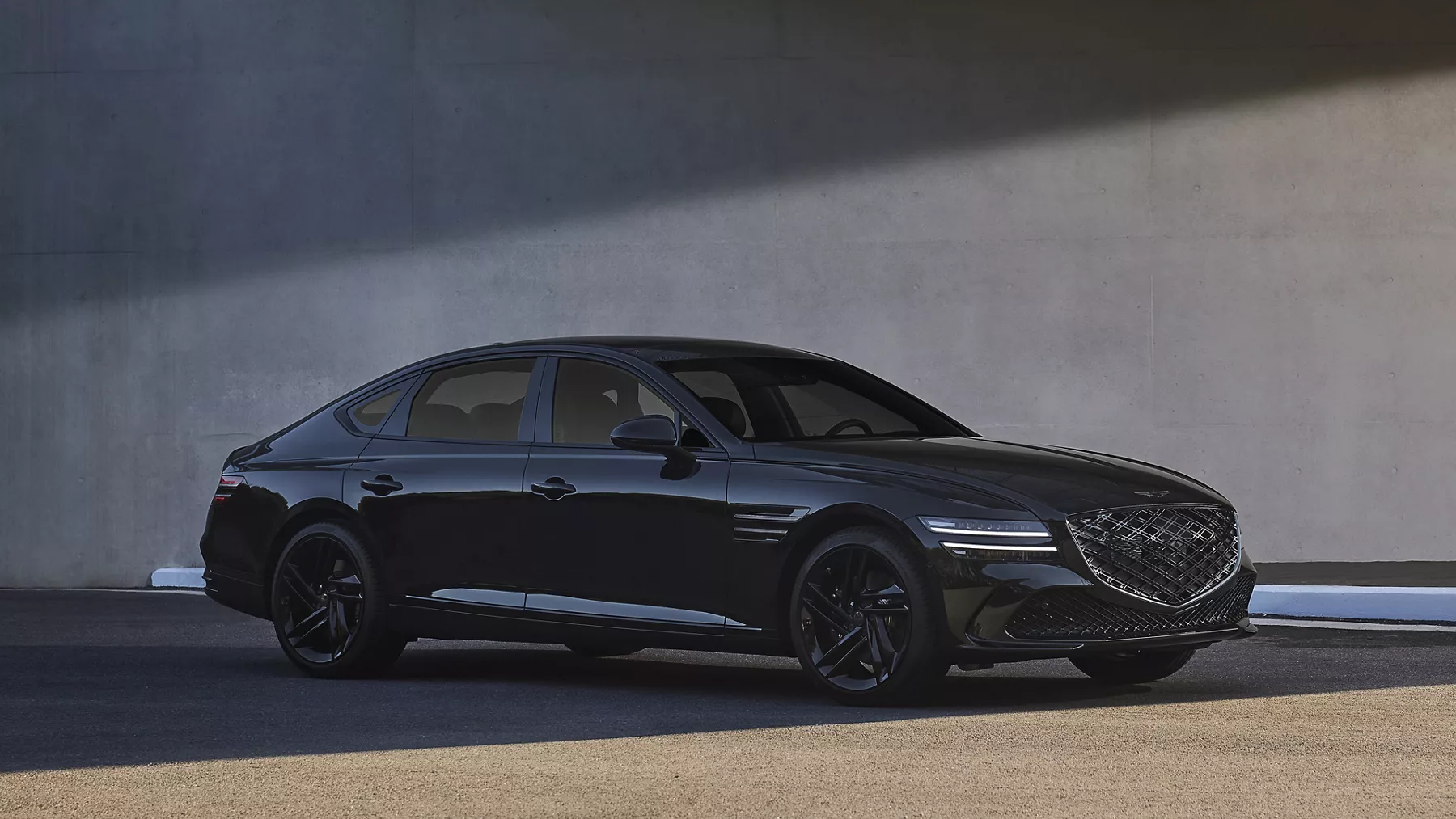 7/8 passenger side view of Genesis G80 Prestige Black parked next to a modern building
