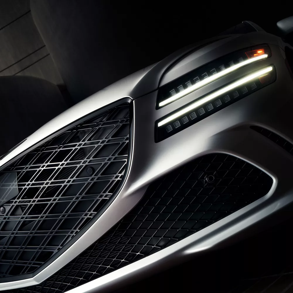 3/4 front driver side closeup of grille and headlight details on Genesis G80 Prestige Black