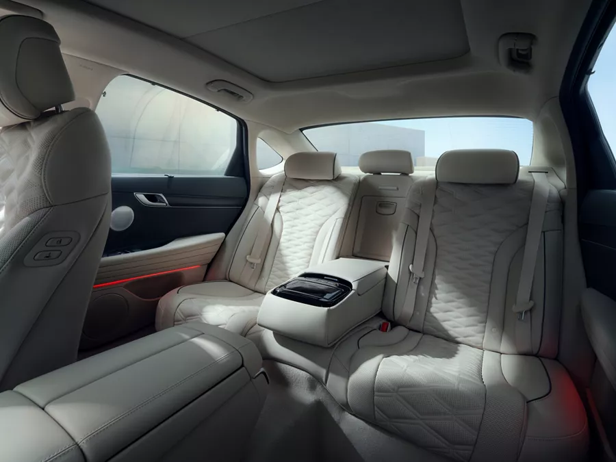 Interior driver seat pov of rear seating in Urban Brown / Glacier White inside the Genesis G80