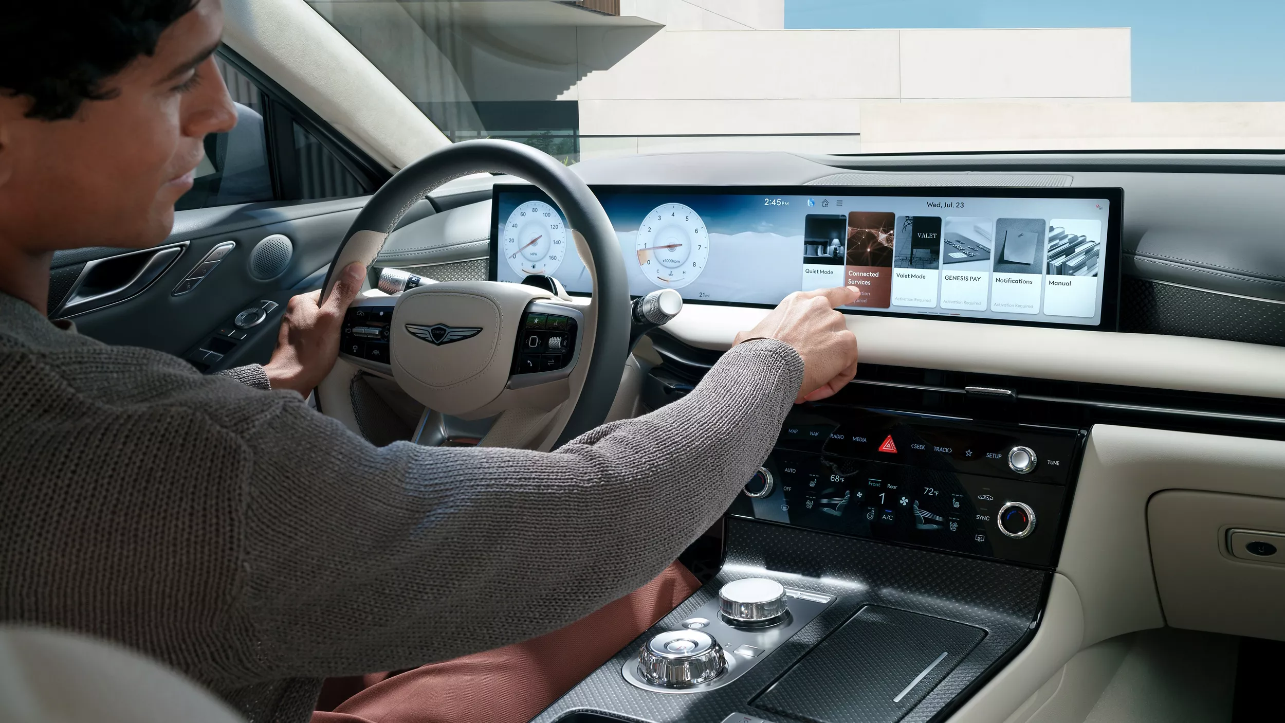 Interior over the shoulder view of driver inside Genesis G80 using 27 inch OLED display