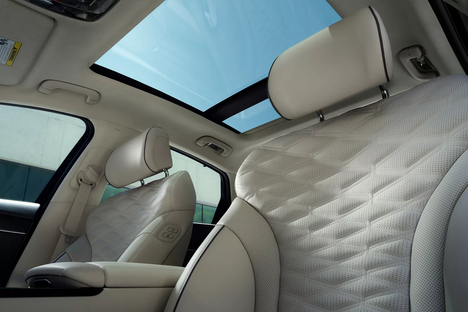 Interior view of sunroof and front seats from driver seat pov inside the Genesis G80
