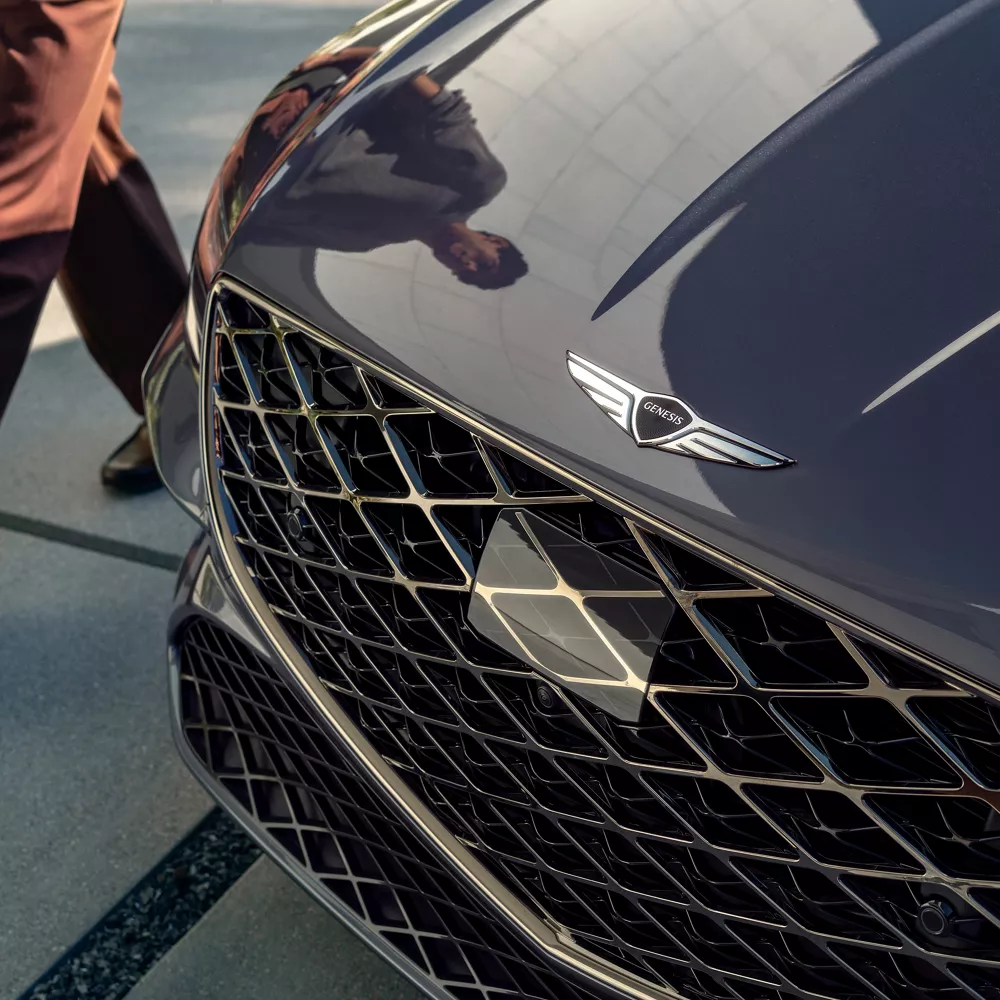 Genesis G80 in Ceres Blue front grille and hood close-up