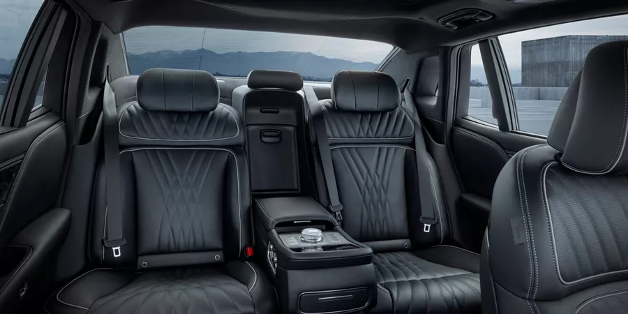 Rear seats in Black Monotone inside Genesis 2026 G90 with view of mountains out of back window