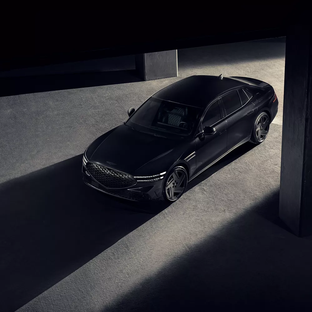 High angle of 2026 Genesis G90 in Prestige Black parked in a dimly lit parking garage