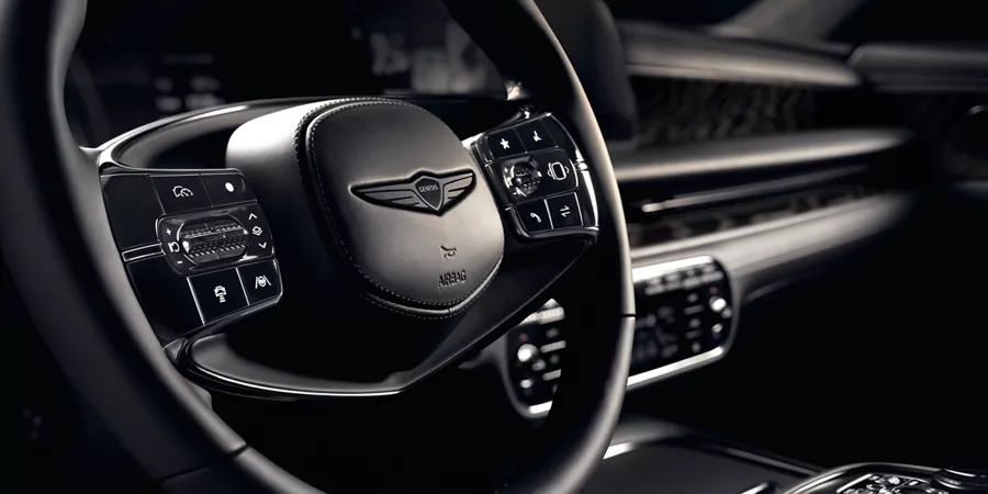 Close up of steering wheel details inside the 2026 Genesis G90 Prestige Black