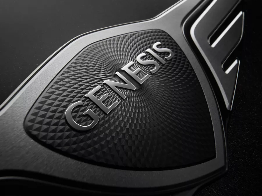 Close up of Genesis logo on steering wheel of 2026 Genesis G90 in Prestige Black