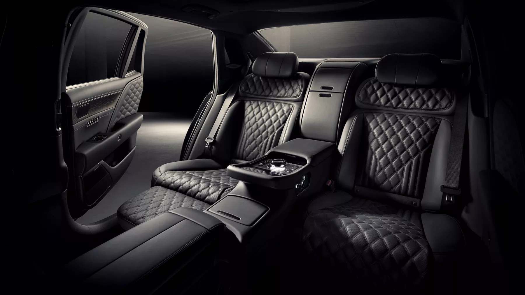 Rear seats of 2026 Genesis G90 in Prestige Black with back passenger door open