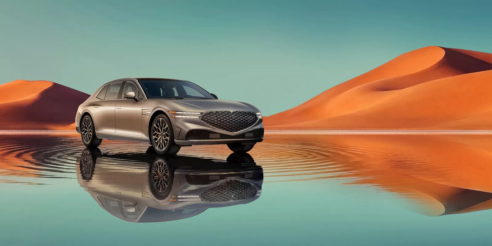7/8 front passenger view of Savile Silver Genesis G80 on blue lake w/ orange mountain in background