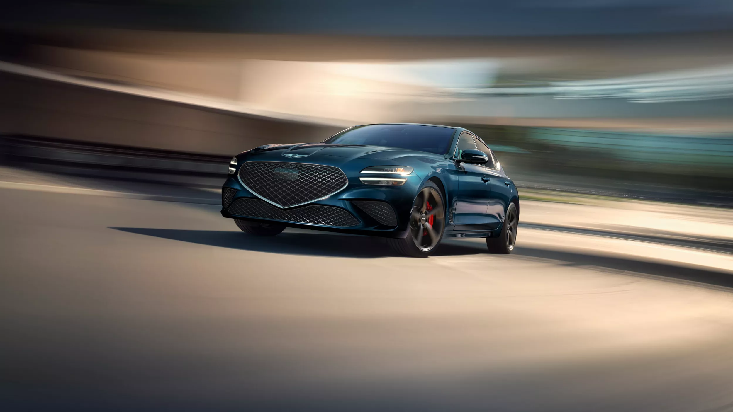3/4 front driver side view of 2027 Genesis G70 in Tasman Blue against motion blurred background